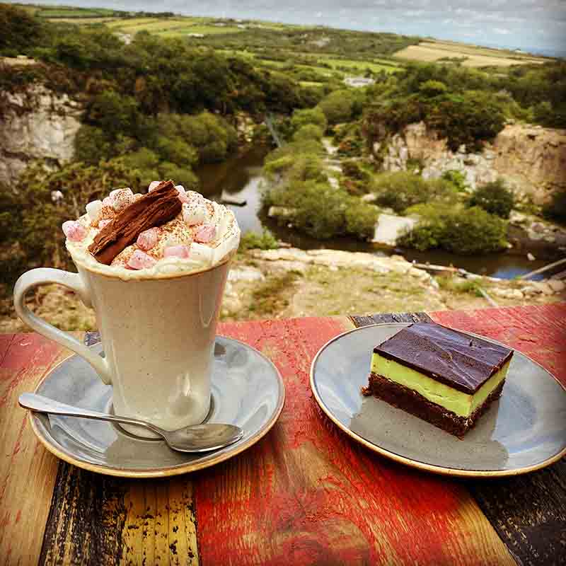 Cafe with wild play areas nearby overlooking the quarry with cake and hot chocolate with marshmallows