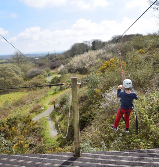 Boy goes zip-lining at our adventure holiday club