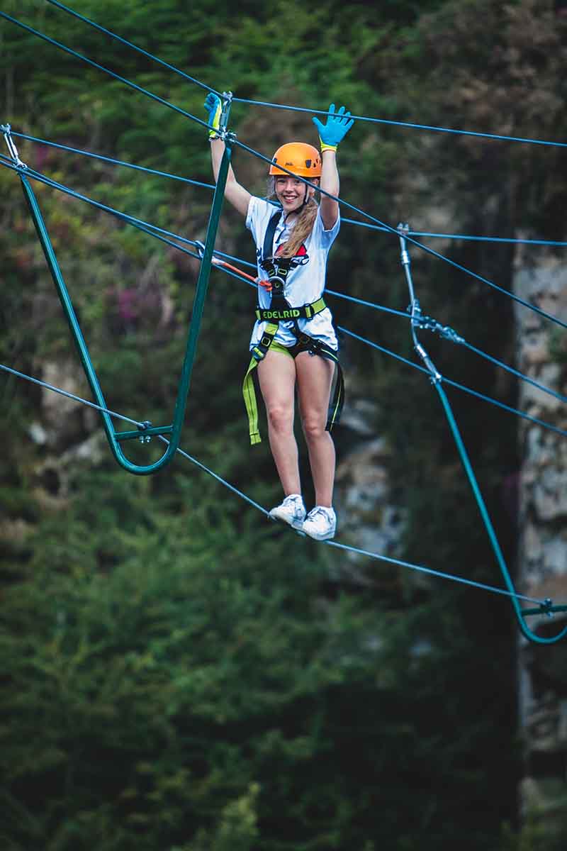 Adventure Day Out at Via Ferrata Cornwall - person enjoying the high wire bridge