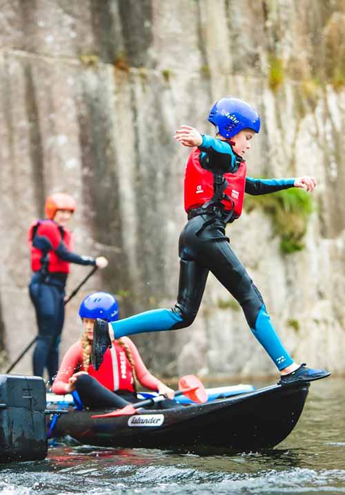 Boys kayaking at watersport session at Via Ferrata Cornwall