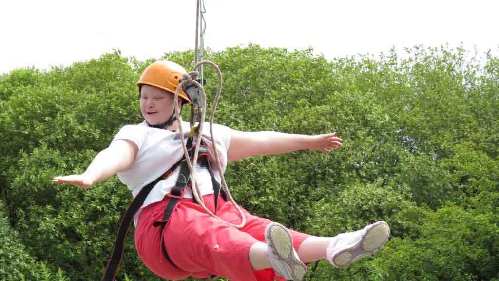 Boy on accessible zip wire at BF Adventure