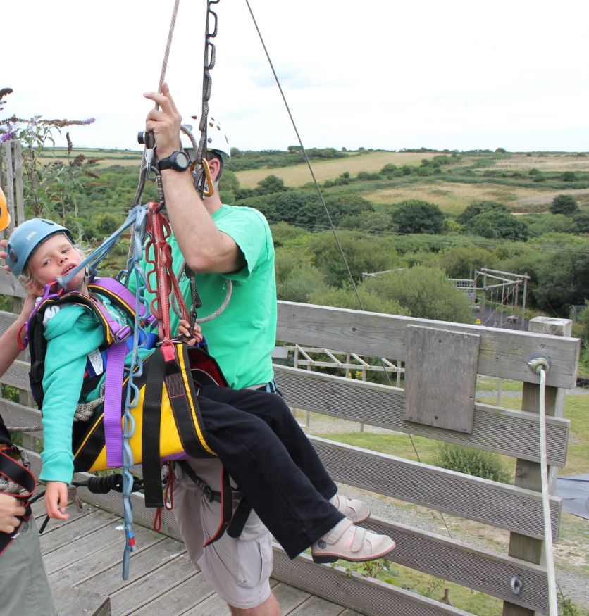 Young person using the accessible zip wire