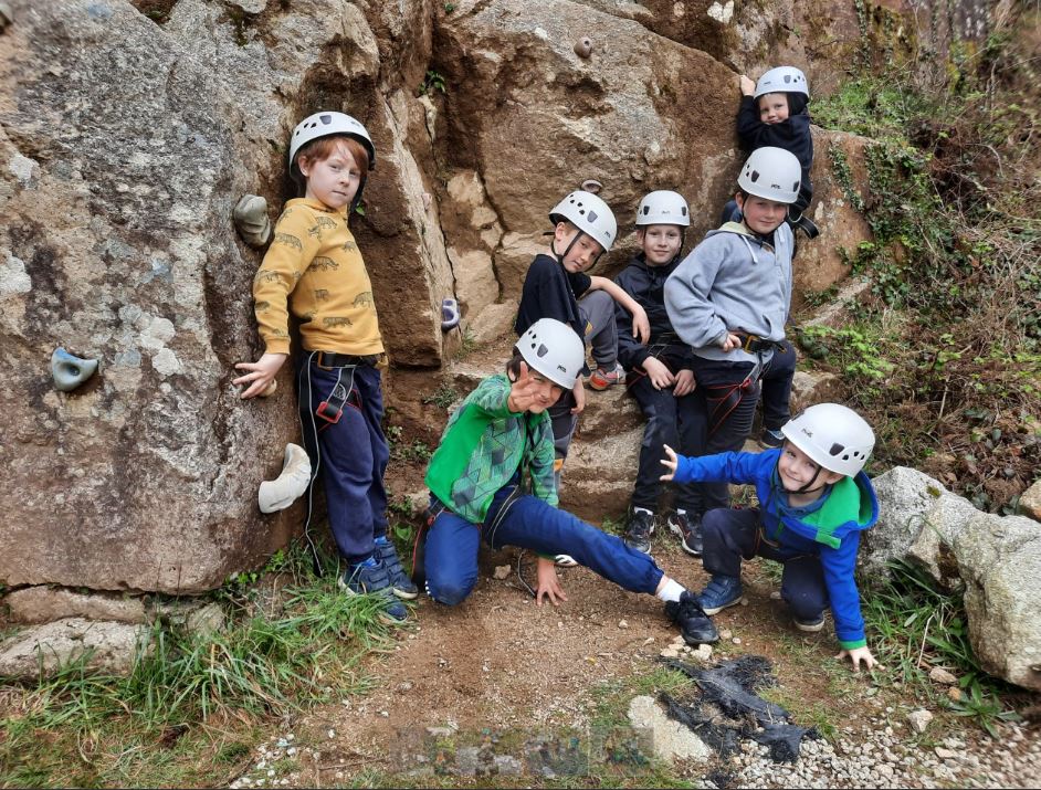 Group rock climbing on a school trip activity